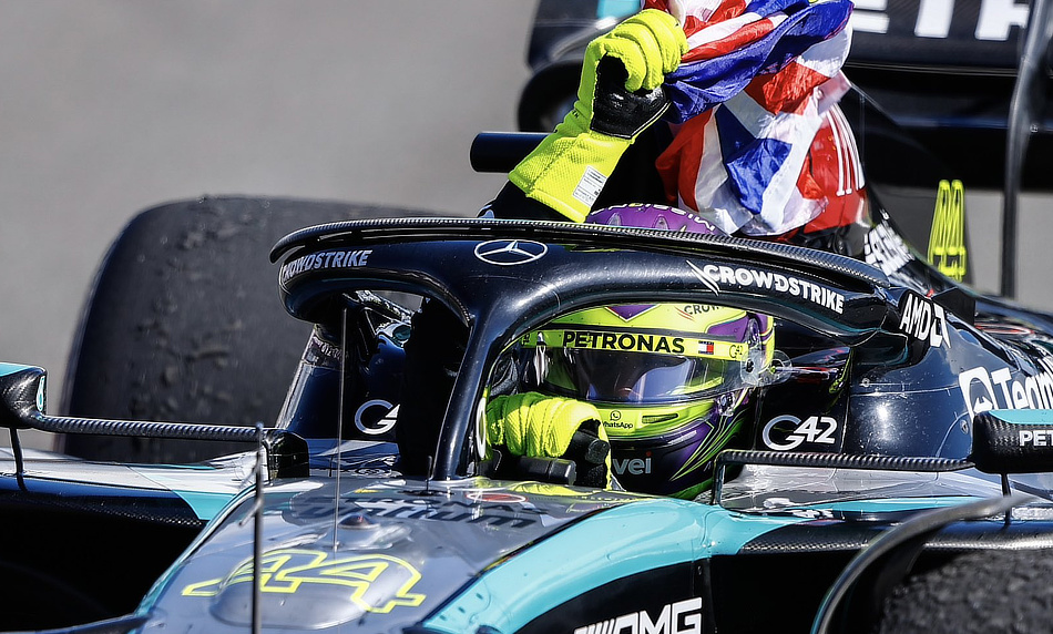 2024 British Grand Prix - Lewis Hamilton waves the British flag on his slow down lap.
